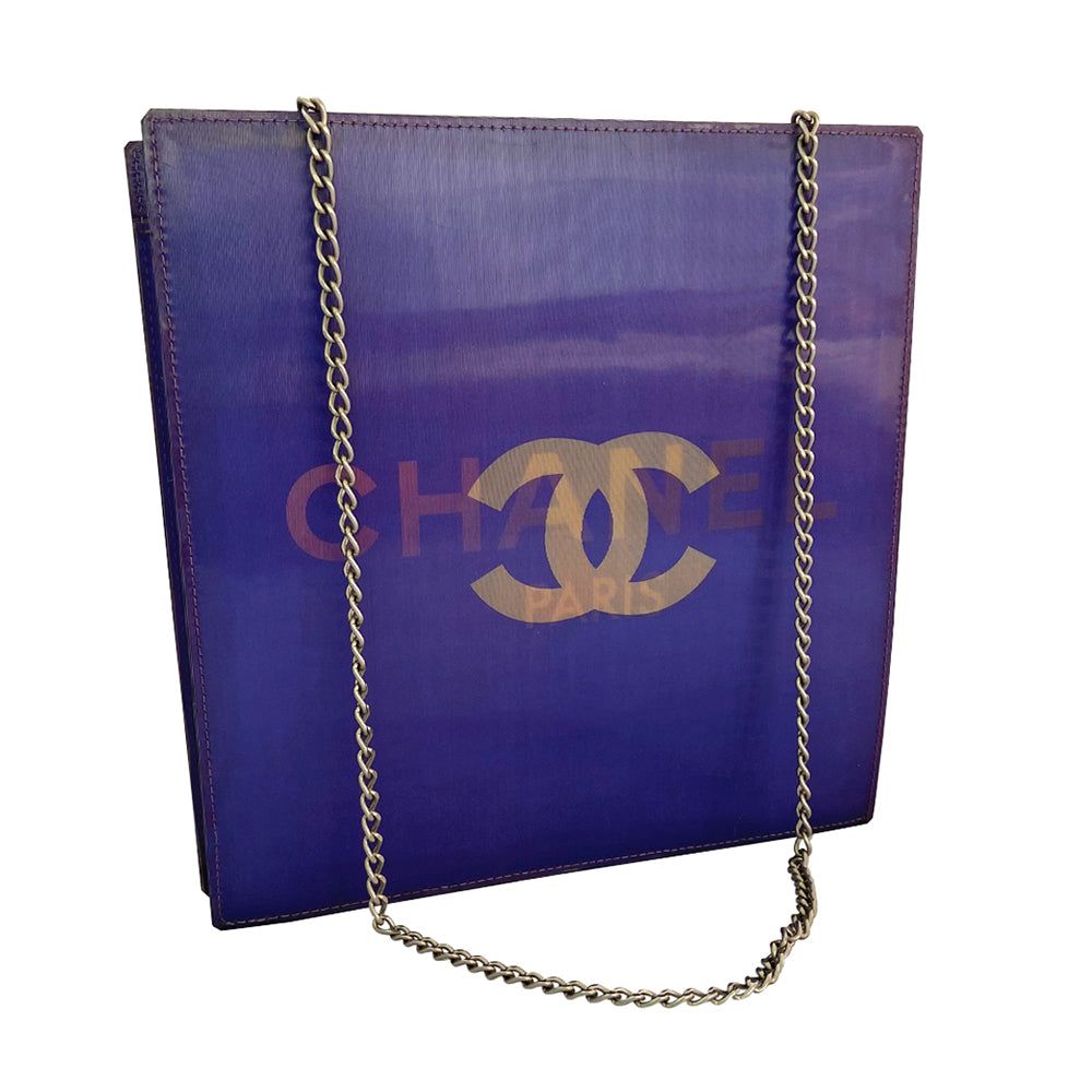 Chanel shoulder bag by Karl Lagerfeld for Chanel 2000. Rectangular vinyl bag with silver-tone double chain shoulder strap and lenticular/holograph design that flip flops between gold-tone interlocking CC logo and CHANEL Paris. Open top, vinyl interior, one zippered pocket. Made in France