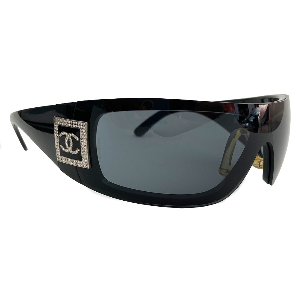 Chanel Crystal Wrap Logo Sunglasses, circa Mid 2000’s in excellent condition, no scratching on lenses. Wrap style frames and removable lenses with crystal logo at temples. Color: Black lens and frame. Style: 5086 Original box, case and cleaning cloth and cards included All in excellent condition