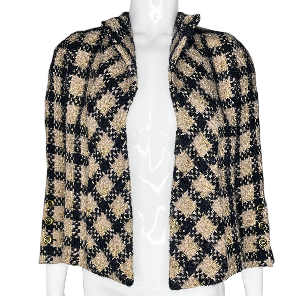 Chanel 1994 gold & black tweed jacket by Karl Lagerfeld for Chanel, autumn 1994 with wrist length sleeves, single snap button closure. Three Chanel CC gold & black buttons on each sleeve. Made in France
