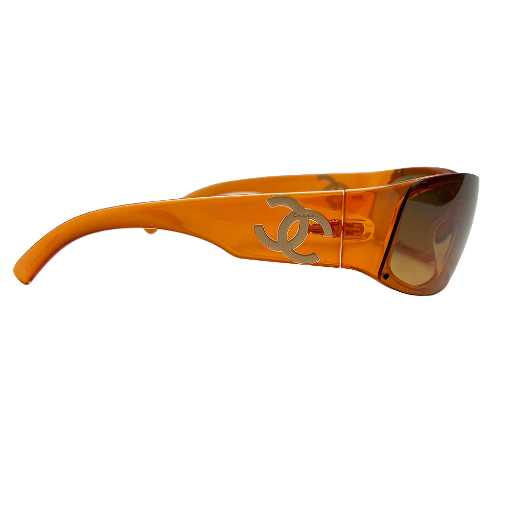 Chanel Translucent Orange Frame CC Logo Sunglasses. Curved rectangular acetate frame with prominent CC gold-tone logo at each arm. Brown gradient lens Style: 5072 Hard case included Excellent condition, very minimal scratches on lens, case in good condition Made in Italy