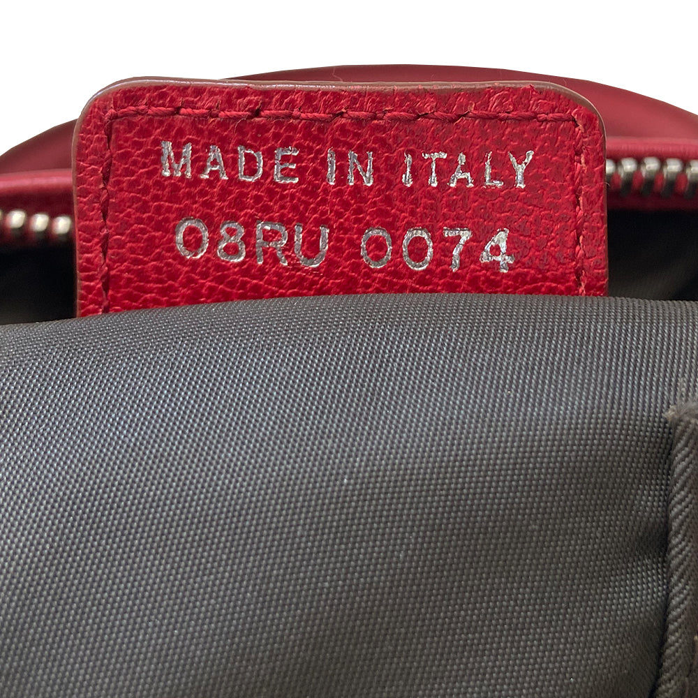 Christian Dior ad campaign Rasta Boston Bag by John Gallian for Dior. Beige and light brown Diorissimo canvas with silver-tone hardware, domed feet, 2 red leather rolled top handles, zipper pulls and end tab and red, yellow and green leather piping and tri-color leather front stripe. Made in Italy