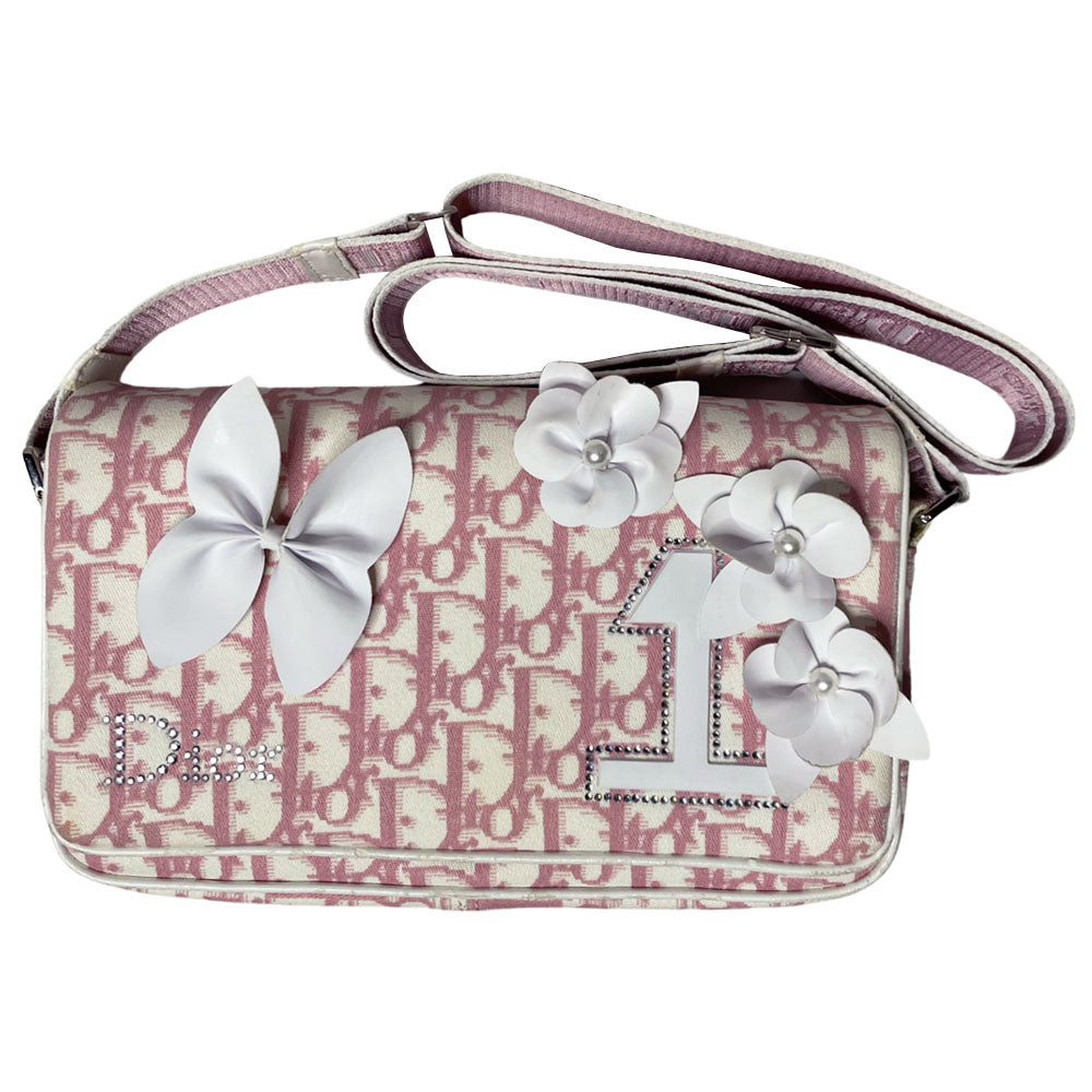 Christian Dior pink monogram canvas girly flap bag by John Galliano for Dior 2004 with pearl center white flowers, white patent piping, Swarovski crystal No 1 and Dior crystal logo. Pink with white edged satin canvas adjustable shoulder strap. Pink textile interior, one interior pocket. Made in Italy