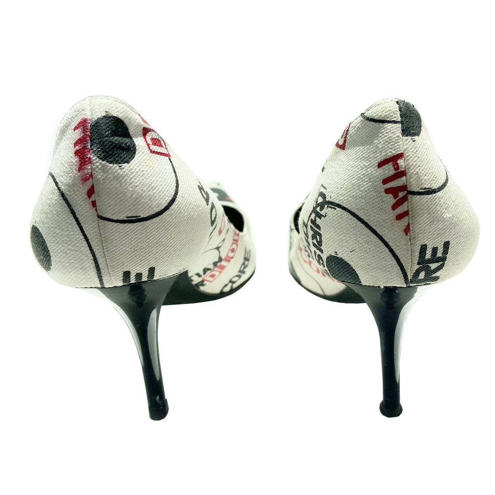 Christian Dior Hardcore Dior canvas pumps by John Galliano for Dior, Circa 2003. Closed toe heeled pump with Hardcore Dior all over print in red and black on white canvas. High gloss black heel with black leather soles and leather Dior logo insoles Size: IT 38.5 Made in Italy