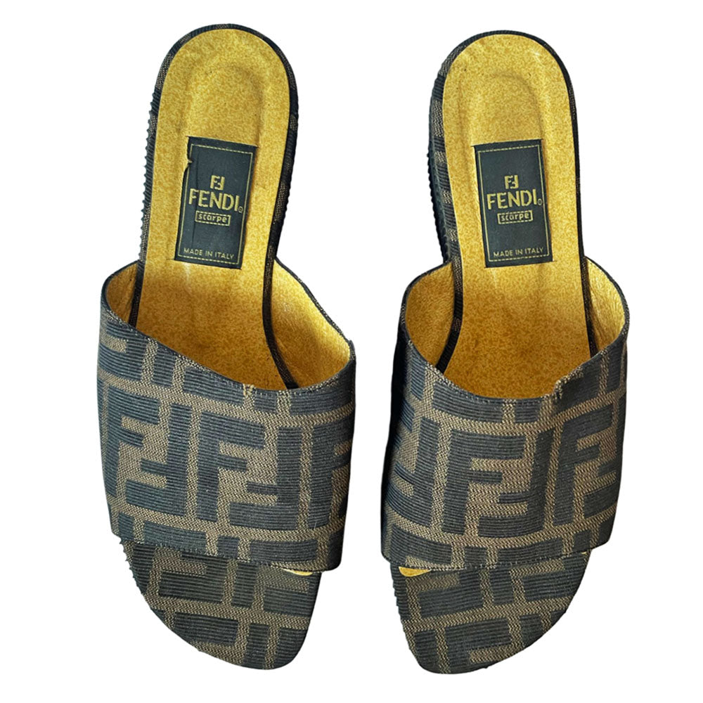 Fendi brown Zucca print fabric upper slip-on open toe slides with 2.5” black ribbed edge platform with small heel. Leather insoles with zucca fabric at inner sole toe, Fendi logo on inner sole, FF logos imprinted at outer platform. Made in Italy.