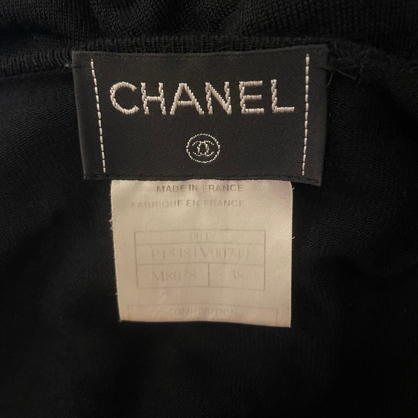 Karl Lagerfeld for Chanel, 2001 intarsia knit V-neck black sweater featuring orange, blue with yellow CC logo Camellia flower blossoms. No. M8078. Made in France