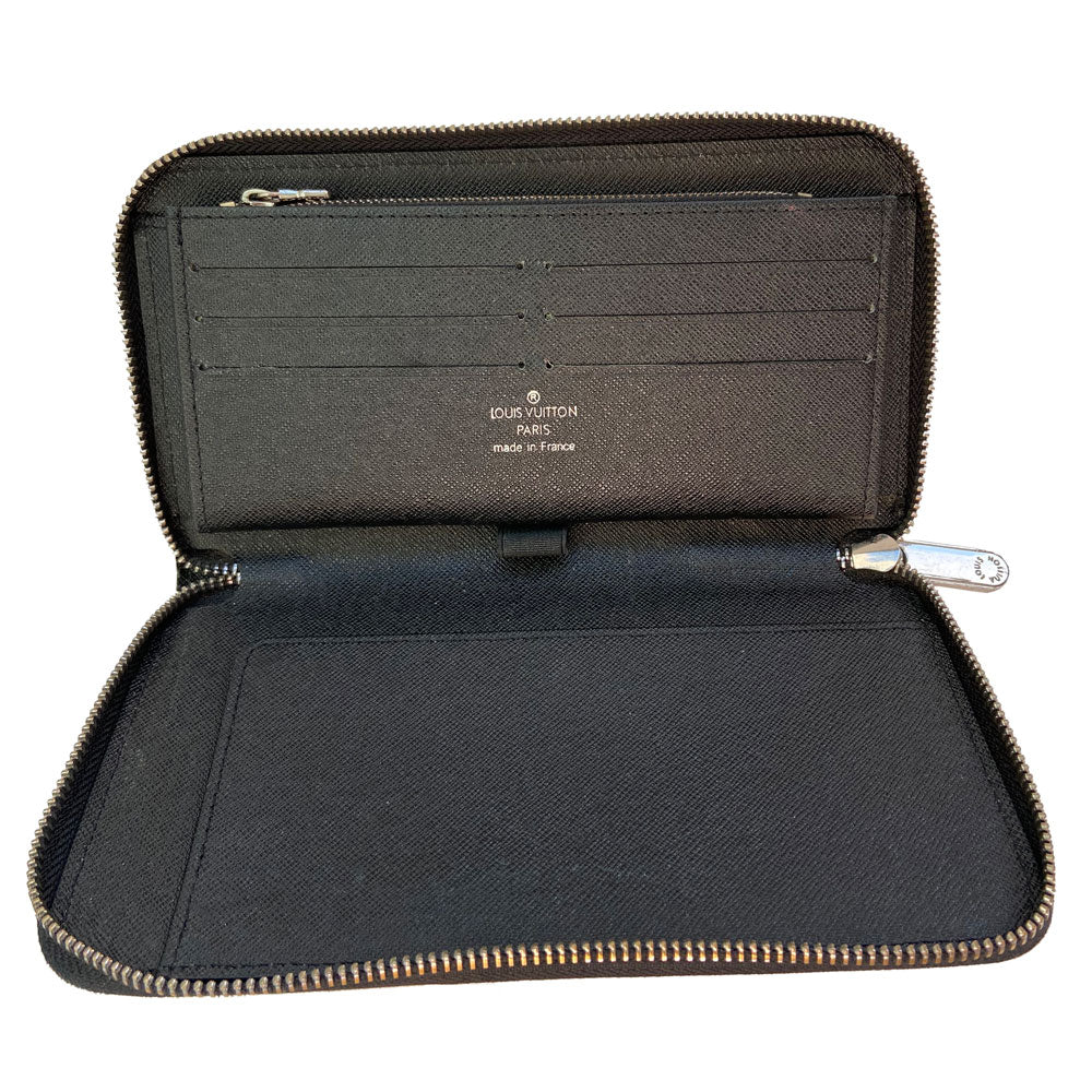Louis Vuitton black epic Zippy Wallet from 2013. Silver-tone zipper and hardware 3 sided outer zipper with bill pocket, zipped coin pocket, 12 card slots, 3 open compartments with 1 bill slot. LV exterior heat stamp, engraved zipper pulls. Interior date code visible. Made in France 