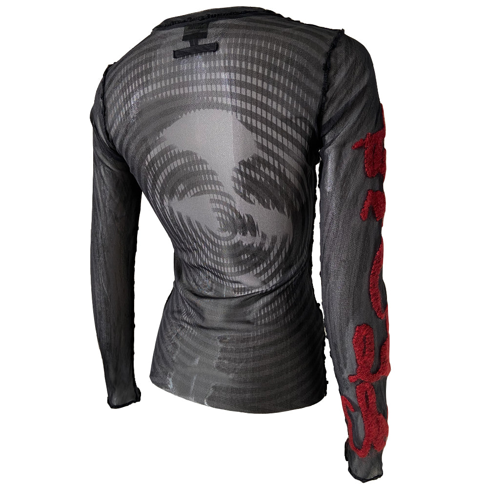 Jean Paul Gaultier Femme rare optical illusion long sleeve mesh top, AW 2001 featuring classic film icon Marlene Dietrich on front and back with red mohair front embroidered script writing and along one sleeve, black boucle accent trim on seams and neckline. Tag size: 40. Made in Japan
