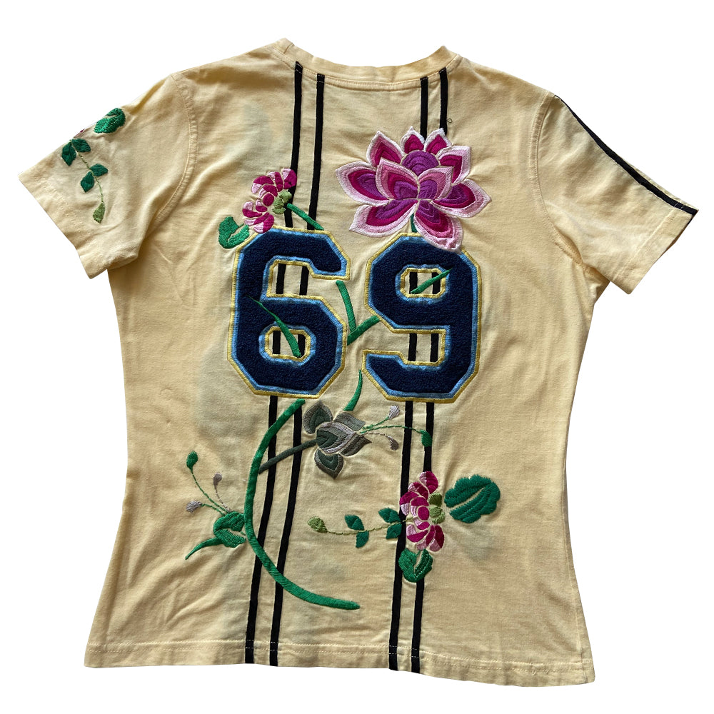 Christian Dior Adiorable 69 short sleeve yellow tee by John Galliano for Christian Dior, FW 2003 with Adiorable 69 front and back appliqué and green, pink, fuchsia embroidered flowering fuchsia plants, koi and lily pads in front, flowers on sleeve, 2 stripes on the other. Size: FR 42 Made in Italy
