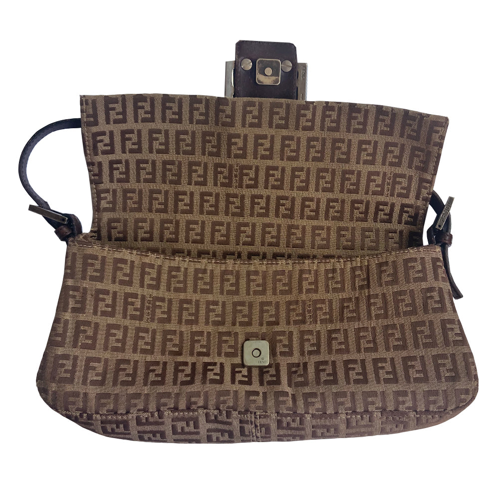 Fendi FF Zucca tan and brown canvas fabric baguette with adjustable chocolate color leather strap and accent, silver-tone Fendi engraved metal hardware and front logo. Front flap with single magnetic closure, canvas interior with Fendi engraved metal plate attached to single slip pocket. Made in Italy