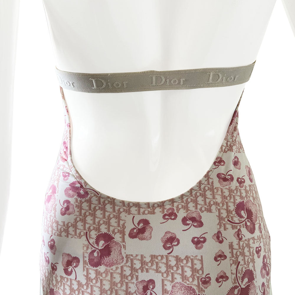 Christian Dior cherry blossom one-piece swimsuit by John Galliano for Dior from 2004 Logo Flowers Collection. Halter style tie neck, deep V neckline and low back. Solid pink upper and cherry blossom monogram lower divided by Dior Logo wide elastic under the bust line and across the back. Size: FR 40. Made in Italy