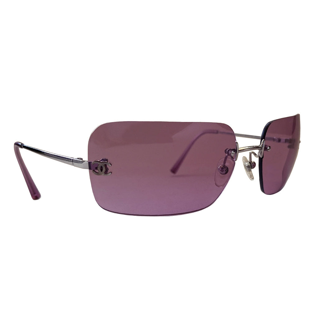 Chanel rimless lens CC logo sunglasses circa 2007 with silver-tone metal arms and Chanel engraved at top of bridge with rimless rectangular purple lenses and inset interlocking CC logos at each lens edge. Style: 4017 Case and cleaning cloth included. Made in Italy