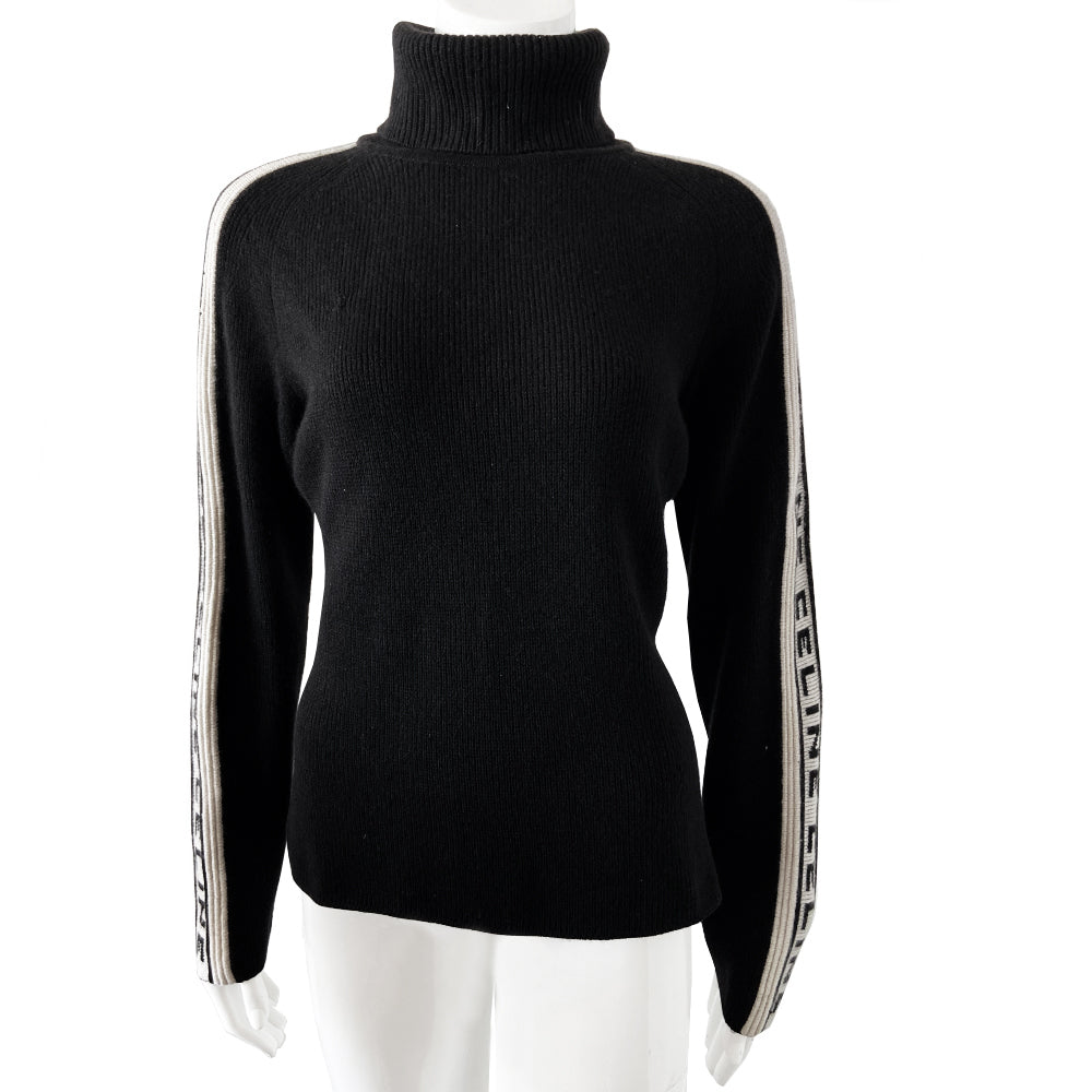 Celine cashmere logo sleeve turtleneck sweater from F/W 1999. Black ribbed high neck with long narrow sleeves and CELINE logo stripe in white and black running from cuff to neck on each arm. Fabric: 100% Cashmere. Size: L Made in Italy.