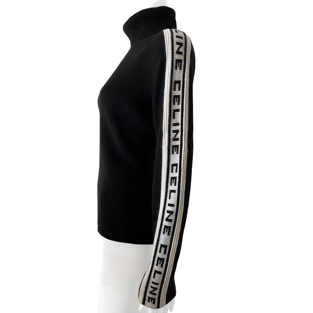 Celine cashmere logo sleeve turtleneck sweater from F/W 1999. Black ribbed high neck with long narrow sleeves and CELINE logo stripe in white and black running from cuff to neck on each arm. Fabric: 100% Cashmere. Size: L Made in Italy.