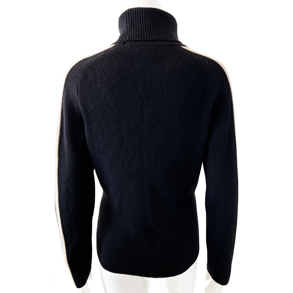 Celine cashmere logo sleeve turtleneck sweater from F/W 1999. Black ribbed high neck with long narrow sleeves and CELINE logo stripe in white and black running from cuff to neck on each arm. Fabric: 100% Cashmere. Size: L Made in Italy.