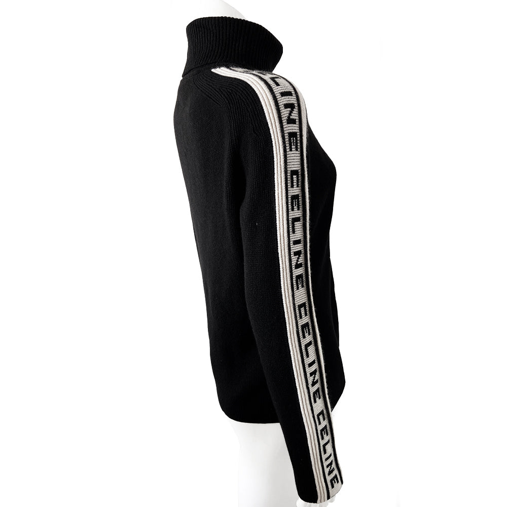 Celine cashmere logo sleeve turtleneck sweater from F/W 1999. Black ribbed high neck with long narrow sleeves and CELINE logo stripe in white and black running from cuff to neck on each arm. Fabric: 100% Cashmere. Size: L Made in Italy.