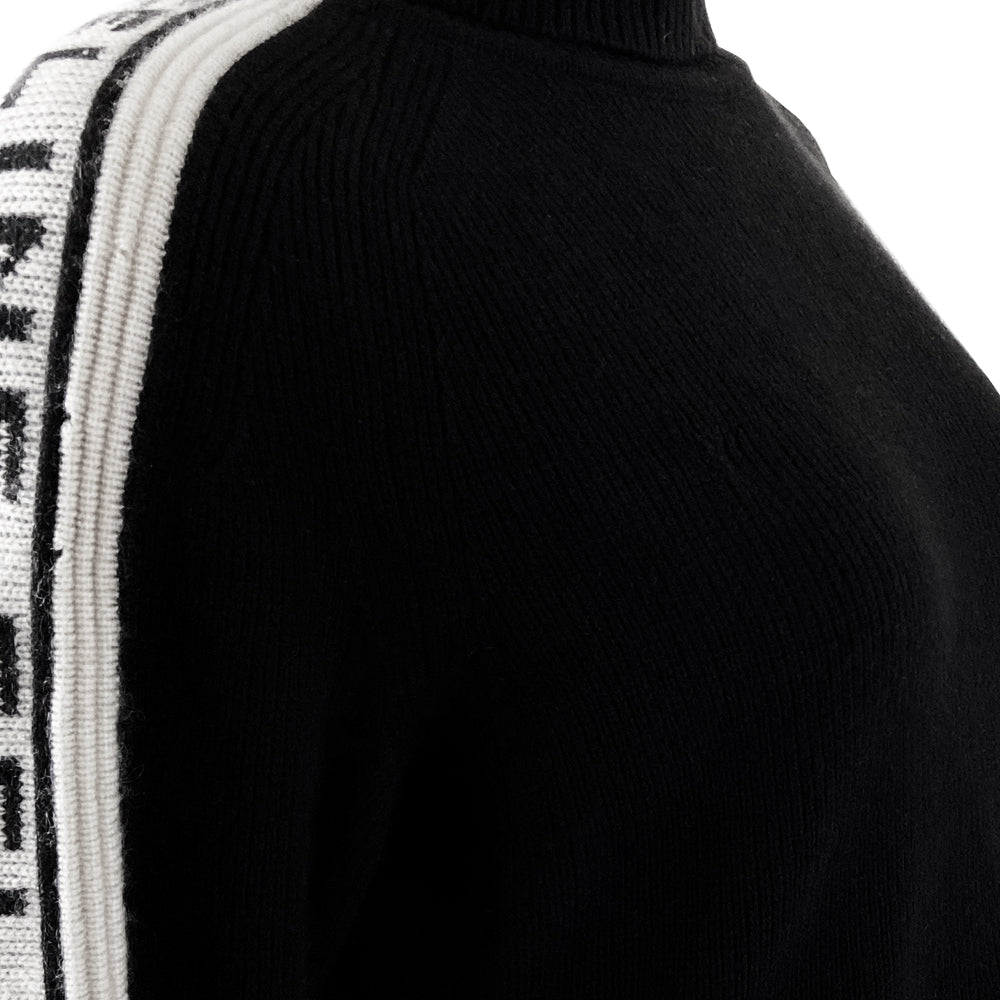 Celine cashmere logo sleeve turtleneck sweater from F/W 1999. Black ribbed high neck with long narrow sleeves and CELINE logo stripe in white and black running from cuff to neck on each arm. Fabric: 100% Cashmere. Size: L Made in Italy.