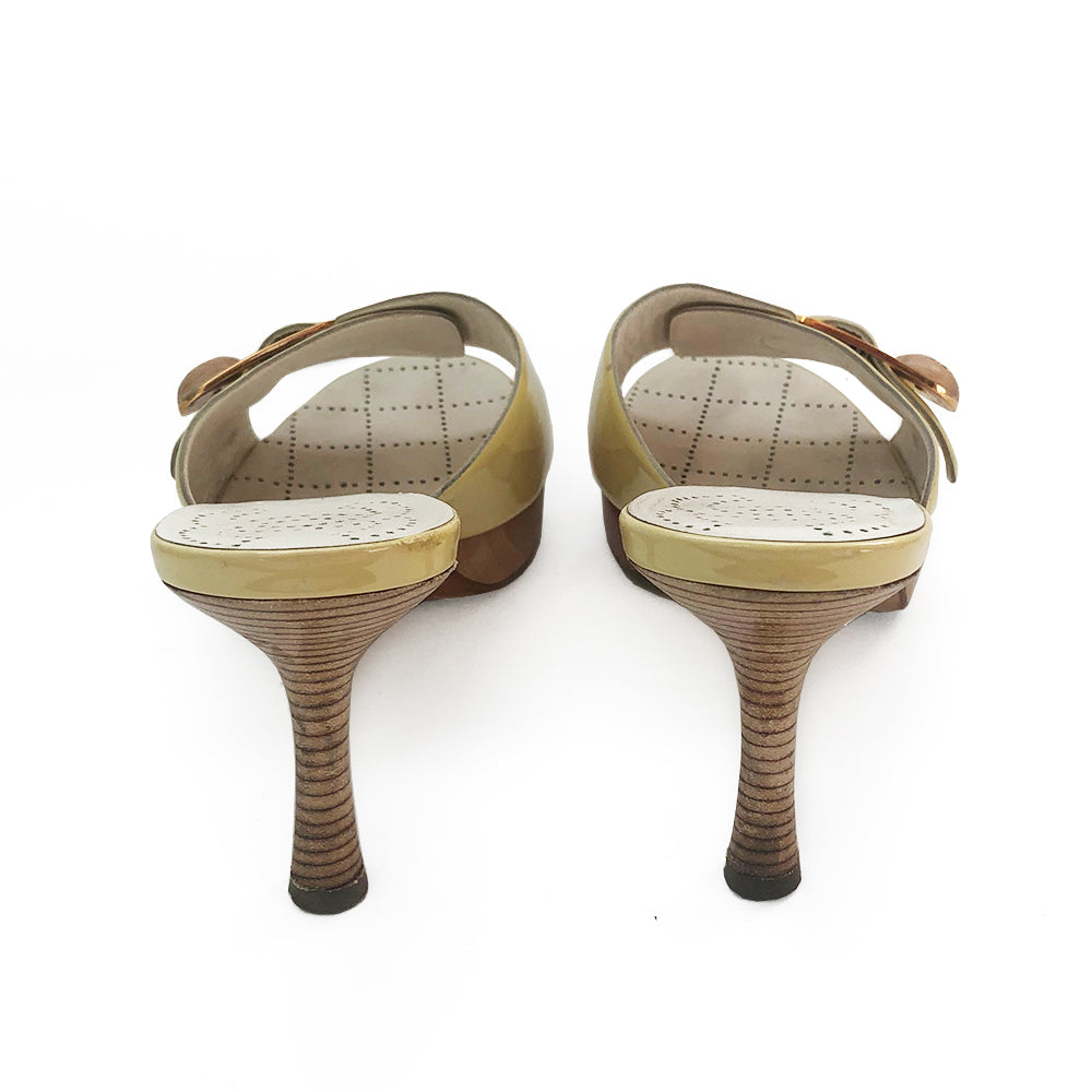 Chanel pale yellow slip on heels, patent leather upper and edges with gold-tone buckle and interlocking CC on wood button detail