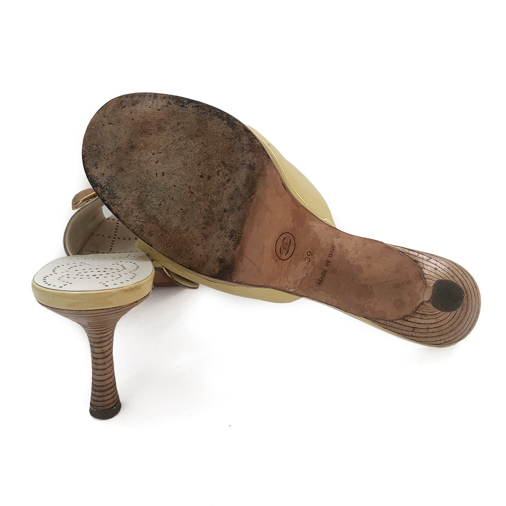 Chanel pale yellow slip on heels, patent leather upper and edges with gold-tone buckle and interlocking CC on wood button detail