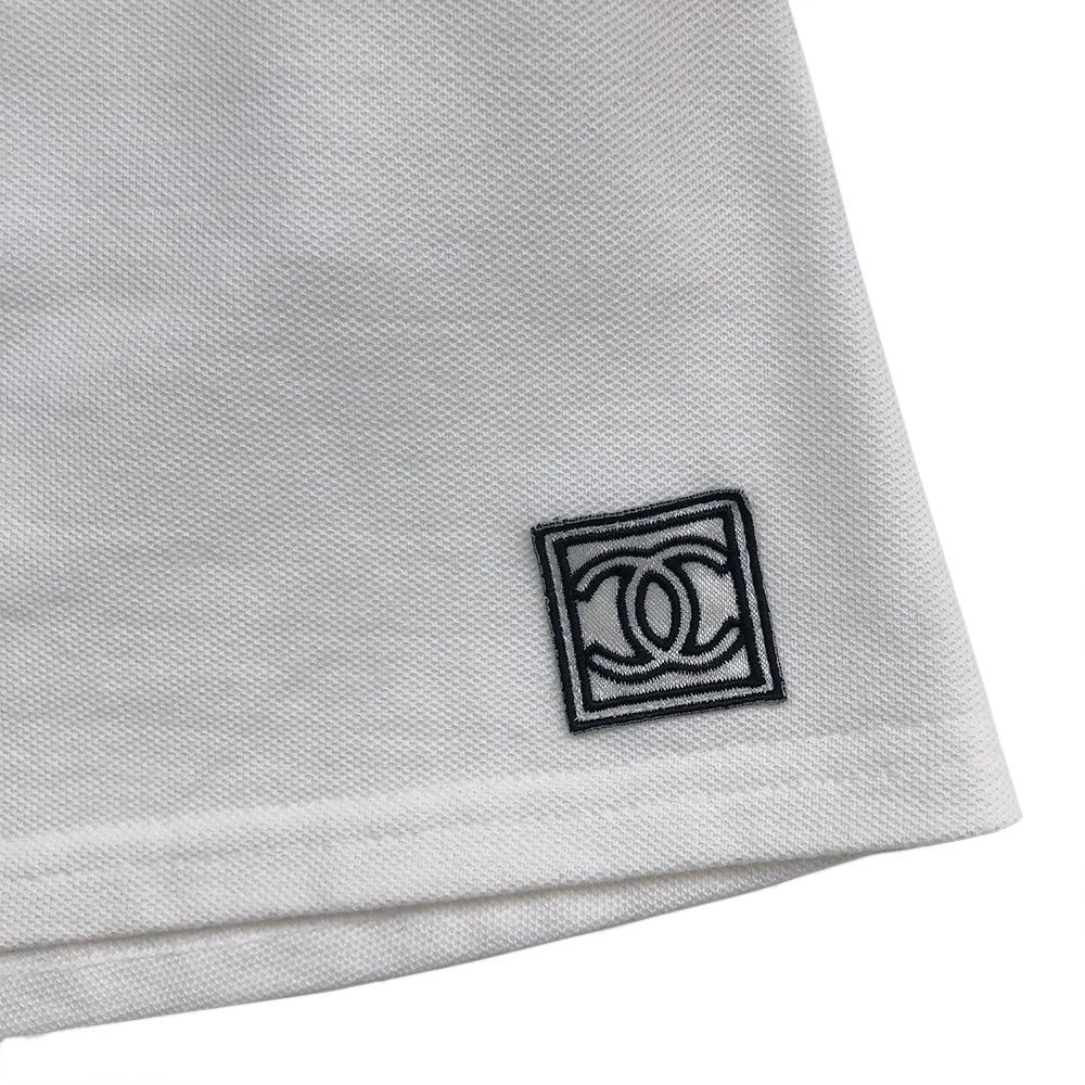 Chanel white tennis skirt, black accents on rib knit front pockets, pique polo fabric, front CC logo