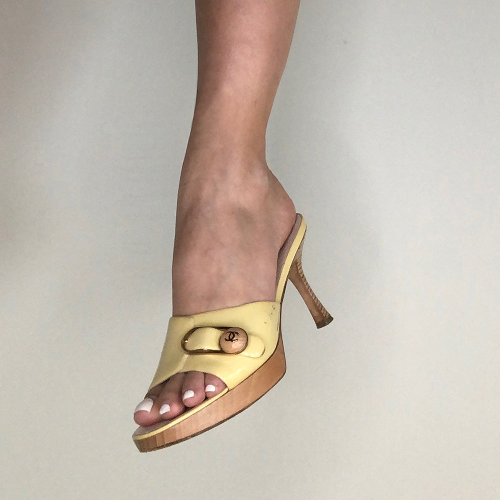 Chanel pale yellow slip on heels, patent leather upper and edges with gold-tone buckle and interlocking CC on wood button detail