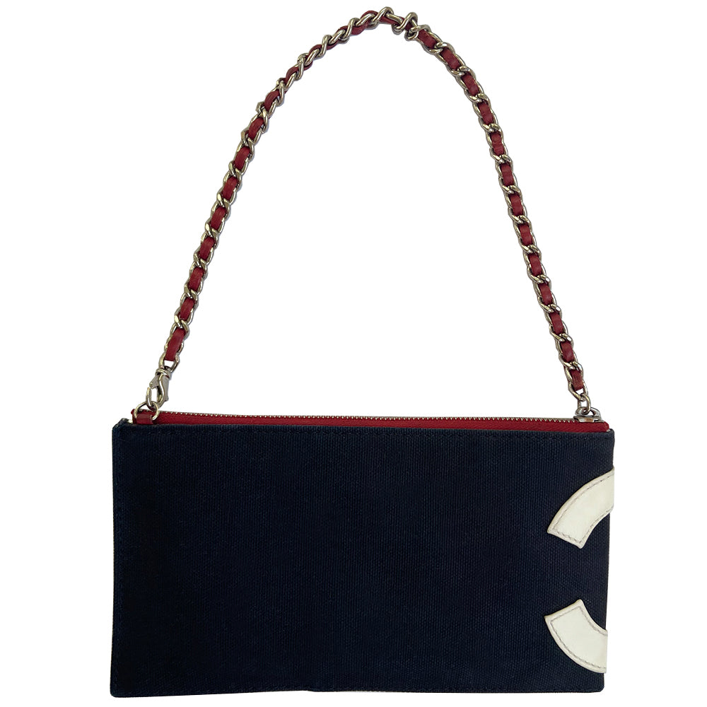 Chanel navy canvas and red, white and silver lamb leather American flag pochette by Karl Lagerfeld for Chanel 2002/2003. Leather CC applique on navy canvas, red leather stripes on quilted silver leather, canvas in back. Silver-tone hardware, red woven leather and chain strap with clip acts as a zipper pull for top zip closure, exterior small pocket. Metallic silver foil vinyl lining. Made in Italy