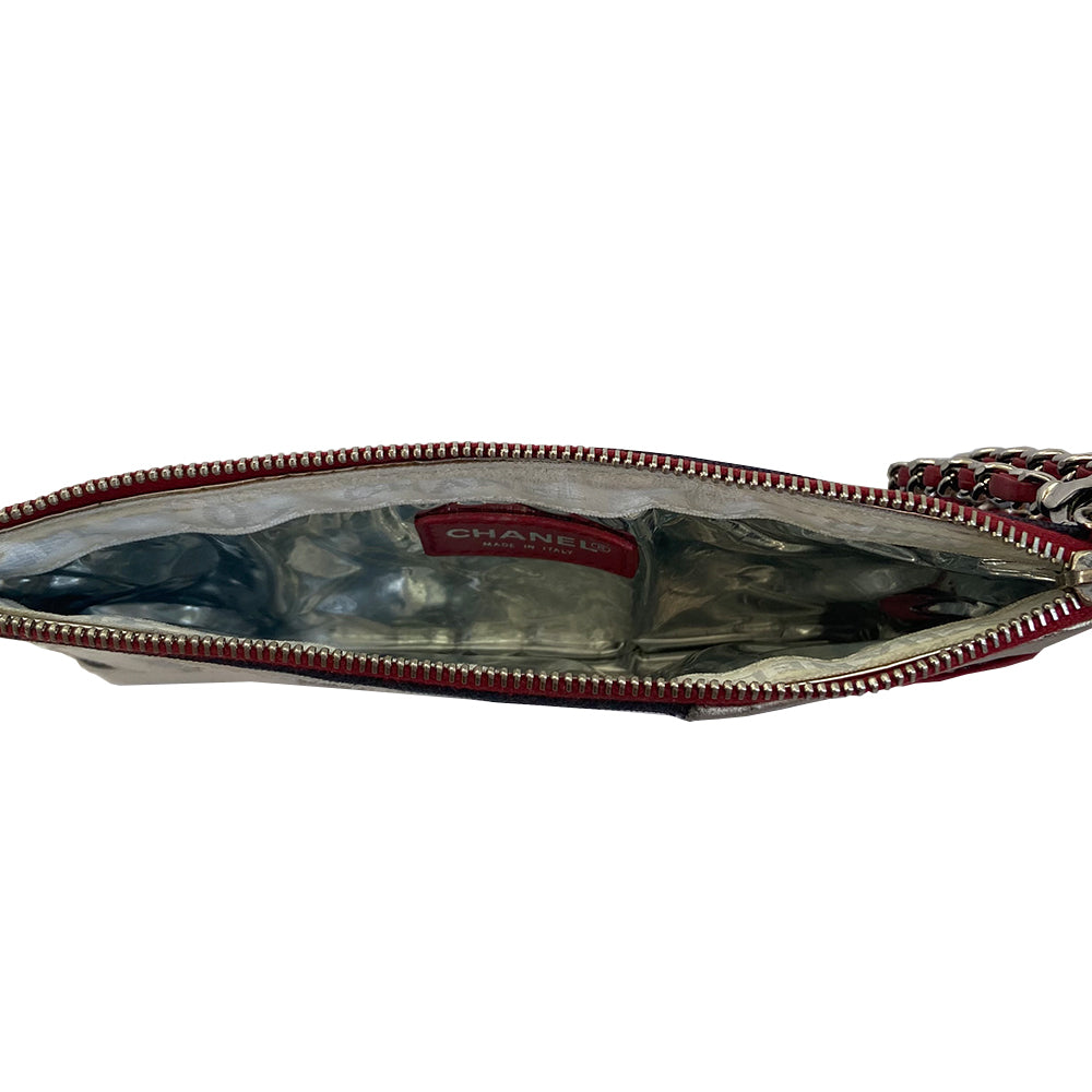 Chanel navy canvas and red, white and silver lamb leather American flag pochette by Karl Lagerfeld for Chanel 2002/2003. Leather CC applique on navy canvas, red leather stripes on quilted silver leather, canvas in back. Silver-tone hardware, red woven leather and chain strap with clip acts as a zipper pull for top zip closure, exterior small pocket. Metallic silver foil vinyl lining. Made in Italy