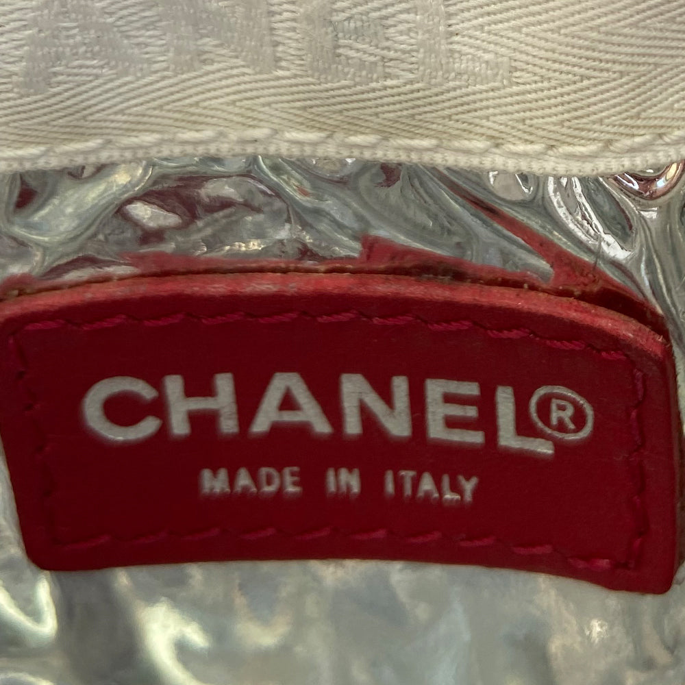 Chanel navy canvas and red, white and silver lamb leather American flag pochette by Karl Lagerfeld for Chanel 2002/2003. Leather CC applique on navy canvas, red leather stripes on quilted silver leather, canvas in back. Silver-tone hardware, red woven leather and chain strap with clip acts as a zipper pull for top zip closure, exterior small pocket. Metallic silver foil vinyl lining. Made in Italy