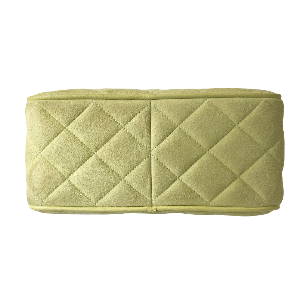 Chanel suede camera bag by Karl Lagerfeld for Chanel, 1991-94. Pistachio color quilted suede, top zipper, etched gold ball and tassels zipper pull, suede and gold chain shoulder strap. Outer flap pocket with engraved gold CC turn-lock, tonal leather lining, patch slip and zippered pocket with gold zipper pull. Made in France