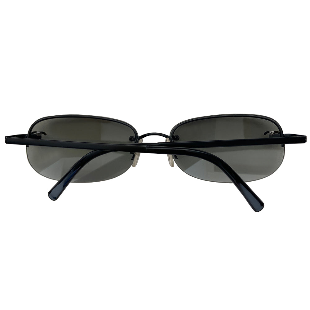 Chanel Black CC logo rectangle shape sunglasses with flat black metal frame along upper and frameless on the bottom with charcoal tinted lenses, black CC logo at each lens, Chanel engraved nose pad. Style: 4099 c.101/11 Made in Italy.
