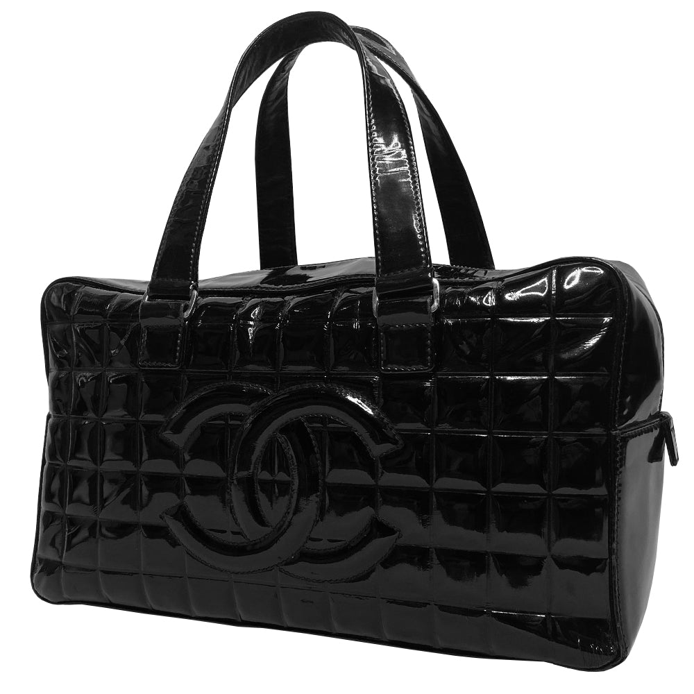 Chanel Chocolate Bar black patent leather quilted rectangular bowler tote by Karl Lagerfeld for Chanel 2003 with prominent interlocking CC front logo and 2 flat top handles, silver-tone hardware and feet. Dual Chanel engraved zipper closure with red microfiber lining and one zip pocket. Made in Italy