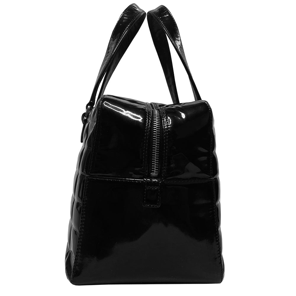 Chanel Chocolate Bar black patent leather quilted rectangular bowler tote by Karl Lagerfeld for Chanel 2003 with prominent interlocking CC front logo and 2 flat top handles, silver-tone hardware and feet. Dual Chanel engraved zipper closure with red microfiber lining and one zip pocket. Made in Italy