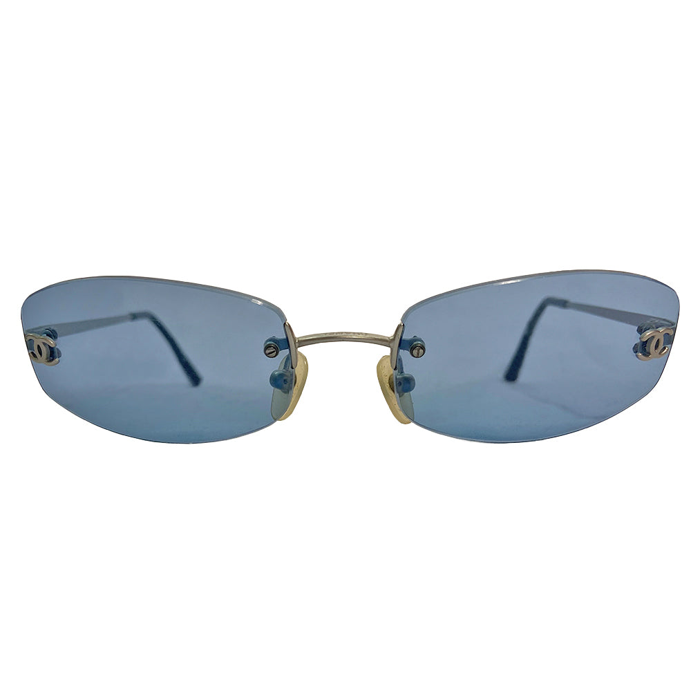 Chanel Blue Lens Frameless Sunglasses Circa 1990’s in excellent condition. Rectangular blue rimless lenses with CC logo in silver on each lens. Arms: Silver-tone arm on each side Style: 4002 103/72 Made in Italy