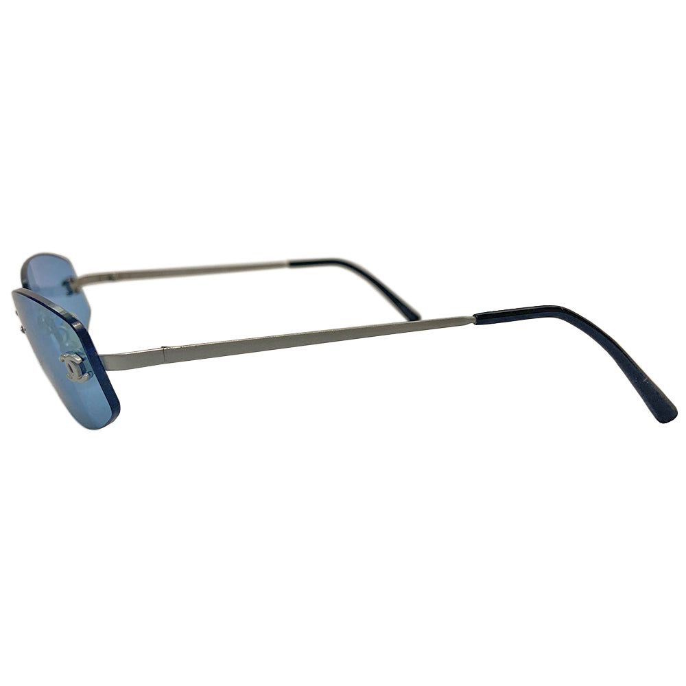 Chanel Blue Lens Frameless Sunglasses Circa 1990’s in excellent condition. Rectangular blue rimless lenses with CC logo in silver on each lens. Arms: Silver-tone arm on each side Style: 4002 103/72 Made in Italy