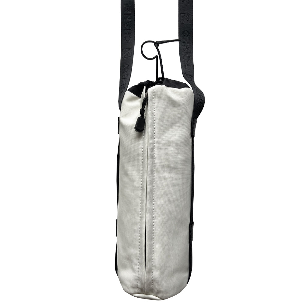 Chanel Sport canvas CC logo draw string water bottle holder by Karl Lagerfeld for Chanel, sport collection 2004. White and black nylon fabric with side zipper and CHANEL nylon webbing, adjustable long strap with sport clip closure. Box CC rubber front logo, black textile interior, date code tag attached. Made in Italy