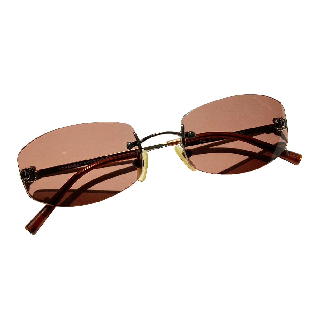 Chanel frameless brown oval lens CC logo sunglasses and silver-tone CC logo on each lens. Silver-tone metal arms with CC logo at the end of each arm. Style: 4002 c116/75 with case. No scratches on glasses, case in good condition Made in Italy