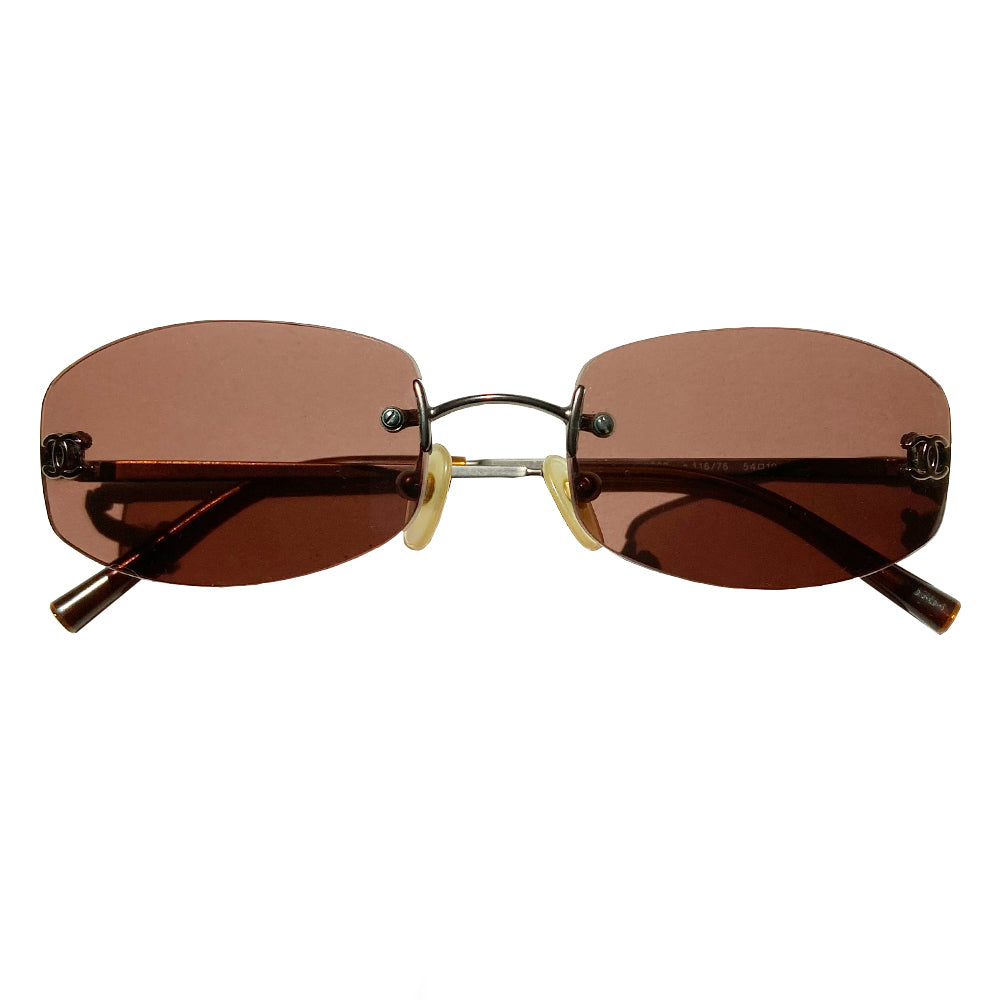 Chanel frameless brown oval lens CC logo sunglasses and silver-tone CC logo on each lens. Silver-tone metal arms with CC logo at the end of each arm. Style: 4002 c116/75 with case. No scratches on glasses, case in good condition Made in Italy