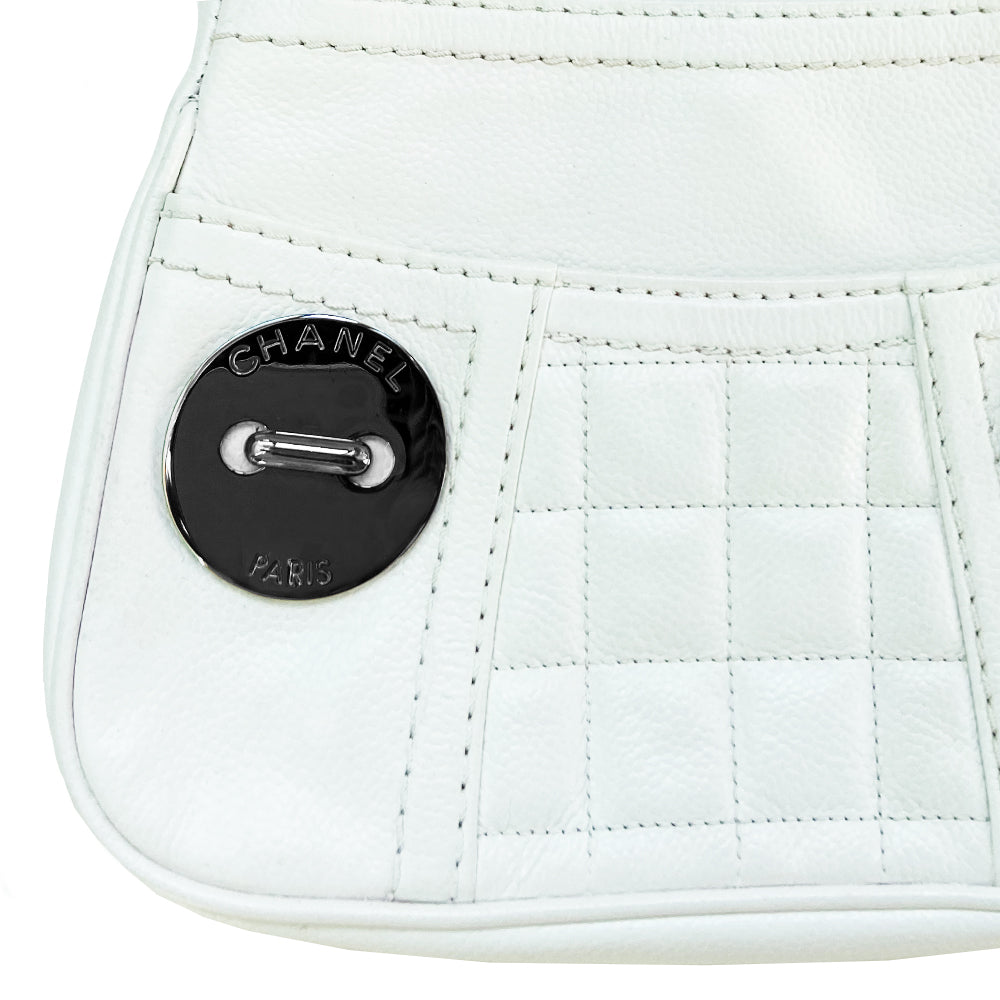 White Chanel Button Chain Quilted Shoulder Bag with 2 Gunmetal front buttons and 2 gunmetal chain link and interwoven leather straps, exterior quilted front pocket. Magnetic snap button closure, burgundy textile jacquard Chanel lining. Chanel Paris engraved on inside clasp. Interior hologram date code tag attached.