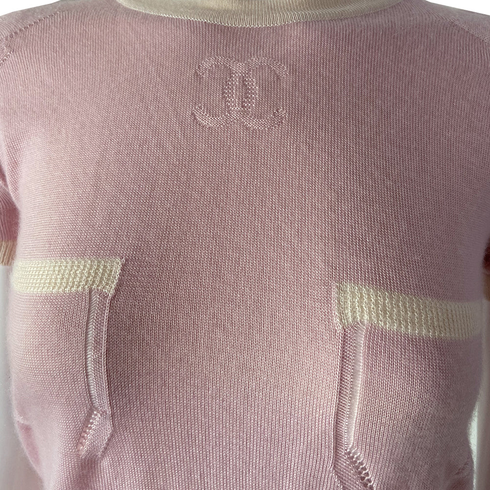 Chanel short sleeve pastel pink cashmere sweater Karl Lagerfeld for Chanel, 2004 with white accent and trim Interlocking CC logo at center chest and 2 front “faux” pockets. Size: FR 38 Made in Italy