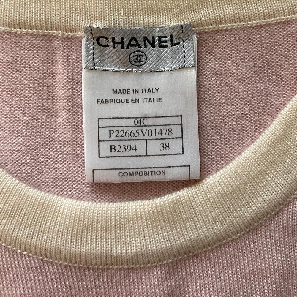 Chanel short sleeve pastel pink cashmere sweater Karl Lagerfeld for Chanel, 2004 with white accent and trim Interlocking CC logo at center chest and 2 front “faux” pockets. Size: FR 38 Made in Italy