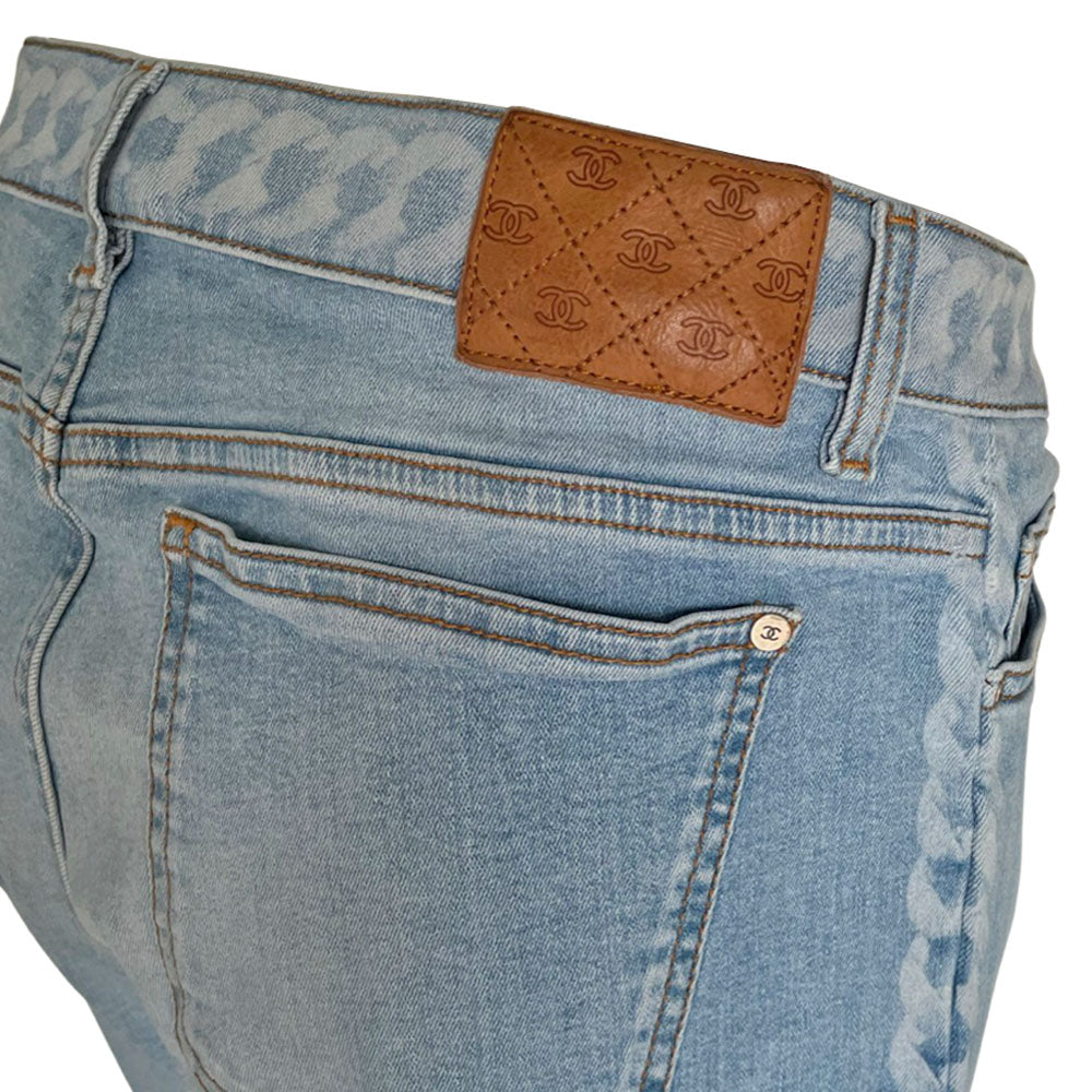 Chanel 2019 mid rise skinny faded wash 5 pocket stretch denim pants with faded white chain link design at waistband and down outer legs, CC engraved logo silver-tone rivets and top button, 5 " CC logo ankle zippers. Belt loops at waistband, calfskin leather diamond stitched CC logo patch at waistband. Made in Italy