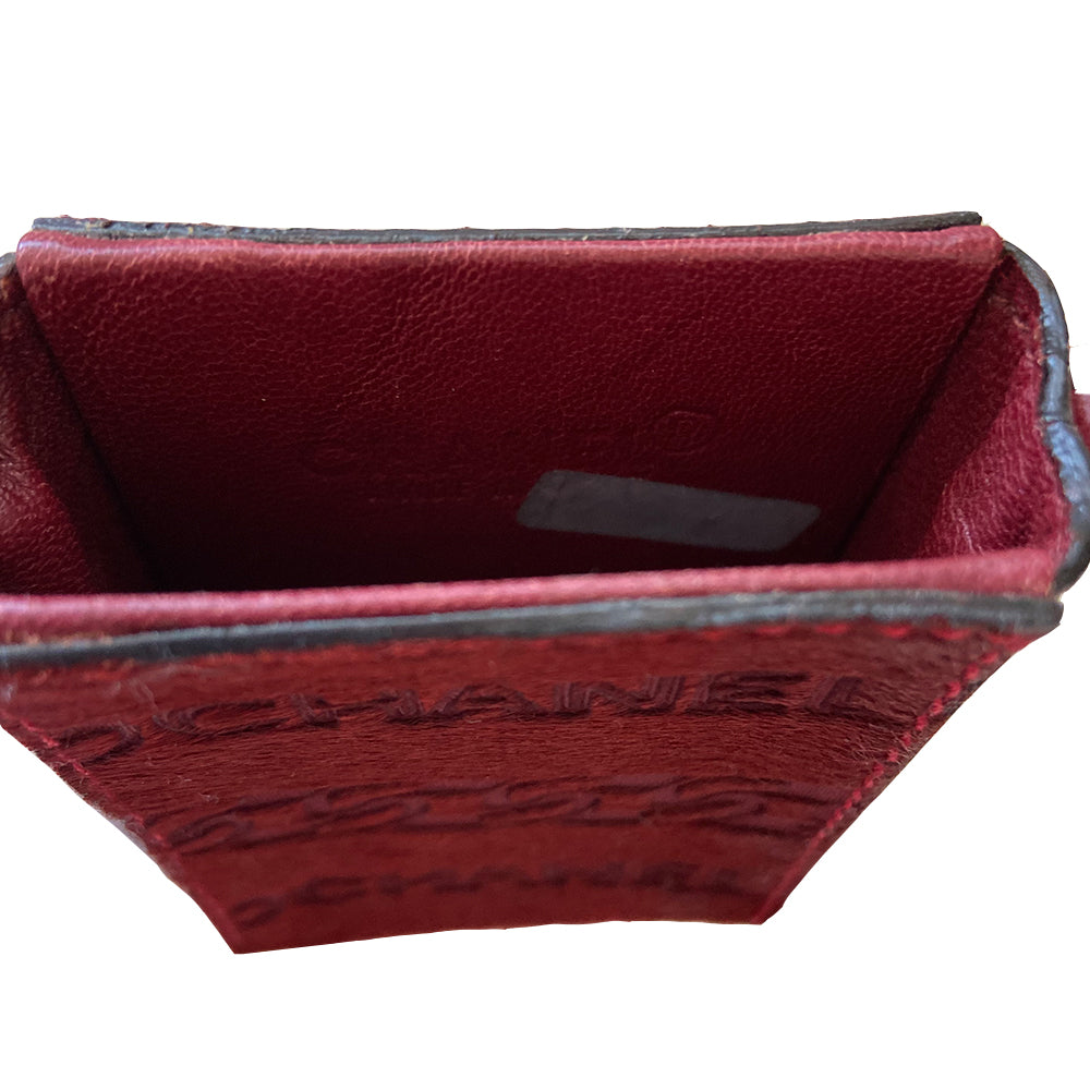 Chanel burgundy pony & lamb leather cigarette case by Karl Lagerfeld for Chanel, circa 2000-2002. Open top mini pouch with CHANEL and interlocking chain design engraved into the pony hair panel on one side, red contrast stitching. Intertwined leather with gold-tone chain. Chanel logo interior stamp. Made in Italy