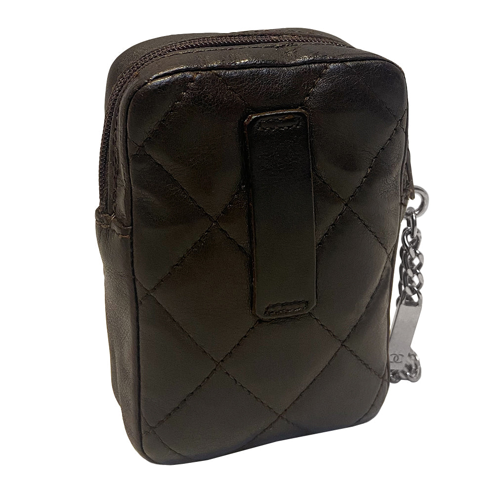 Chanel Cambon quilted brown leather cigarette case by Karl Lagerfeld for Chanel, circa 2004-2005 with outer slip pocket, tonal interlocking CC logo stitched appliqué. Rear leather belt loop, top zip closure with silver-tone metal logo engraved chain zipper pull. Orange CC logo textile lining Interior. Made in France