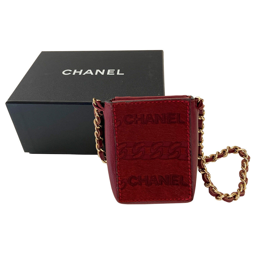 Chanel burgundy pony & lamb leather cigarette case by Karl Lagerfeld for Chanel, circa 2000-2002. Open top mini pouch with CHANEL and interlocking chain design engraved into the pony hair panel on one side, red contrast stitching. Intertwined leather with gold-tone chain. Chanel logo interior stamp. Made in Italy