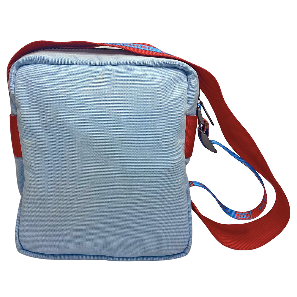 Chanel spring 2002 sport cross body canvas messenger bag by Karl Lagerfeld for Chanel with appliqué embroidered box CC front logo, outer zip pocket with ring zipper pull and long CHANEL CC logo satin webbing adjustable shoulder strap. Top zipper closure with blue vinyl interior, clear vinyl interior slip pocket. Made in Italy