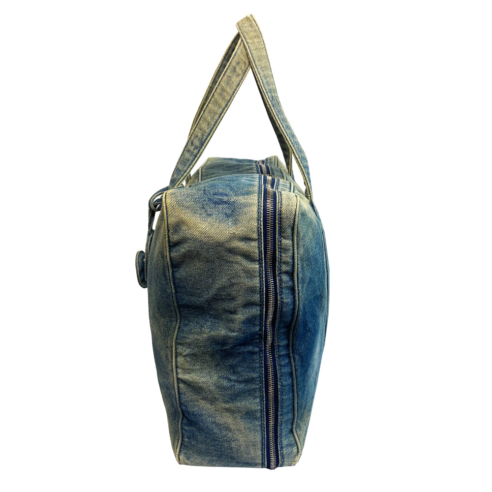 Chanel all over CC logo distressed denim overnight bag by Karl Lagerfeld for Chanel 2003 with detachable key pouch, outer slip pocket, dual zip closure, double carry handles. Jacquard textile CC logo print lining with zippered pocket, elastic compression straps to hold items in place. Serial number sticker attached.