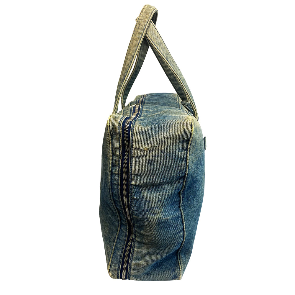 Chanel all over CC logo distressed denim overnight bag by Karl Lagerfeld for Chanel 2003 with detachable key pouch, outer slip pocket, dual zip closure, double carry handles. Jacquard textile CC logo print lining with zippered pocket, elastic compression straps to hold items in place. Serial number sticker attached.