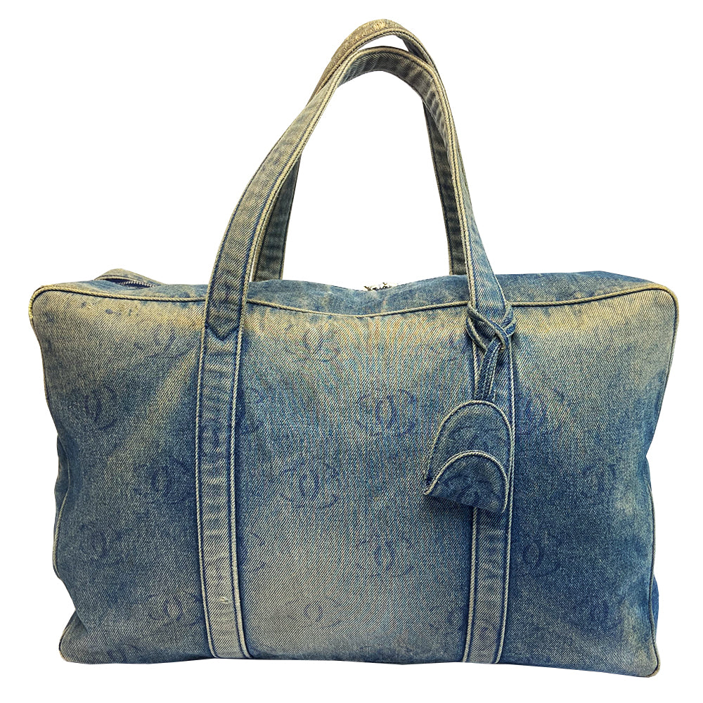 Chanel all over CC logo distressed denim overnight bag by Karl Lagerfeld for Chanel 2003 with detachable key pouch, outer slip pocket, dual zip closure, double carry handles. Jacquard textile CC logo print lining with zippered pocket, elastic compression straps to hold items in place. Serial number sticker attached.