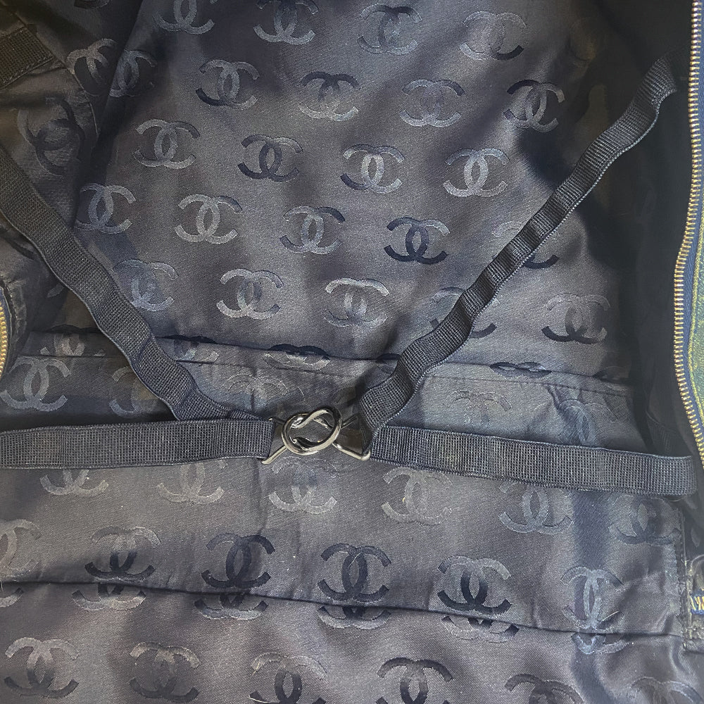 Chanel all over CC logo distressed denim overnight bag by Karl Lagerfeld for Chanel 2003 with detachable key pouch, outer slip pocket, dual zip closure, double carry handles. Jacquard textile CC logo print lining with zippered pocket, elastic compression straps to hold items in place. Made in Italy