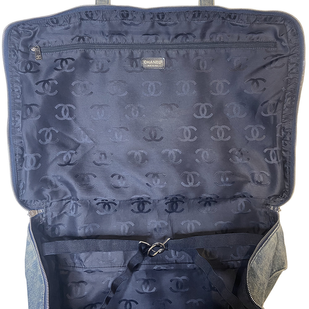 Chanel all over CC logo distressed denim overnight bag by Karl Lagerfeld for Chanel 2003 with detachable key pouch, outer slip pocket, dual zip closure, double carry handles. Jacquard textile CC logo print lining with zippered pocket, elastic compression straps to hold items in place. Made in Italy