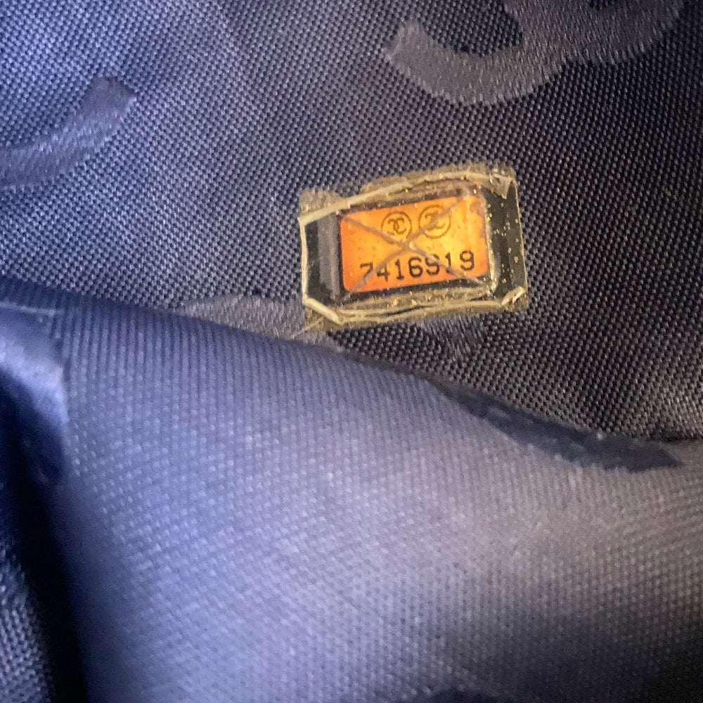 Chanel all over CC logo distressed denim overnight bag by Karl Lagerfeld for Chanel 2003 with detachable key pouch, outer slip pocket, dual zip closure, double carry handles. Jacquard textile CC logo print lining with zippered pocket, elastic compression straps to hold items in place. Made in Italy